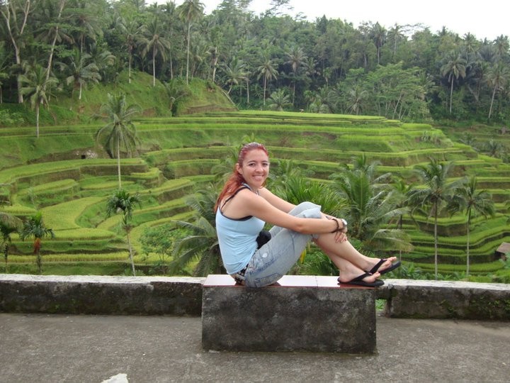 Sharim poses in front of a rice field.
