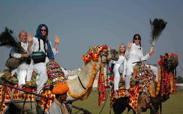 Kimberly, Araya, Kathleen and Elara hold the beam on their festive camels.