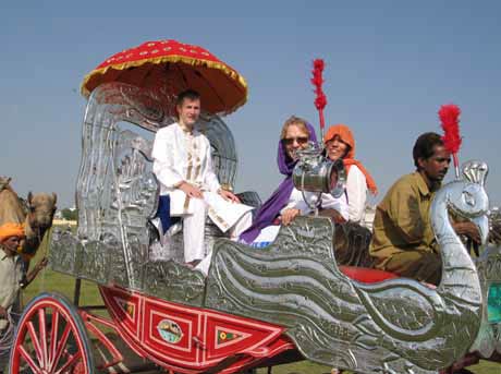 Karon, Mary and Ti-Mon-Ra ride in a silver cart.