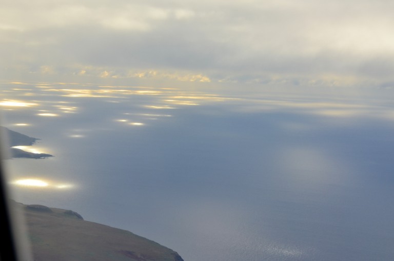 As we flew away from our beloved Rapa Nui, lights shimmered on the ocean.