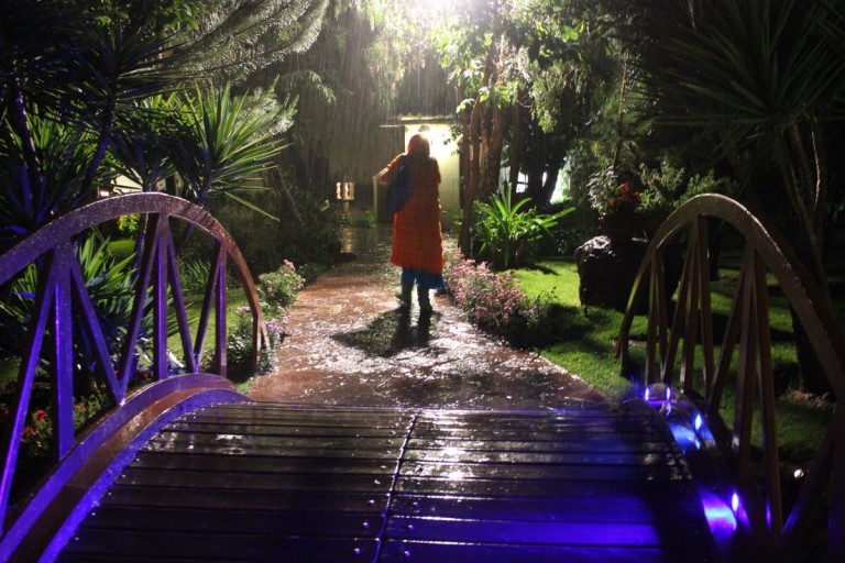 Indigo heads back to her room in the pouring rain.